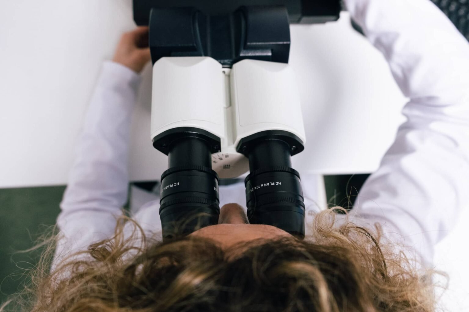 student-analysing-sample-using-a-microscope